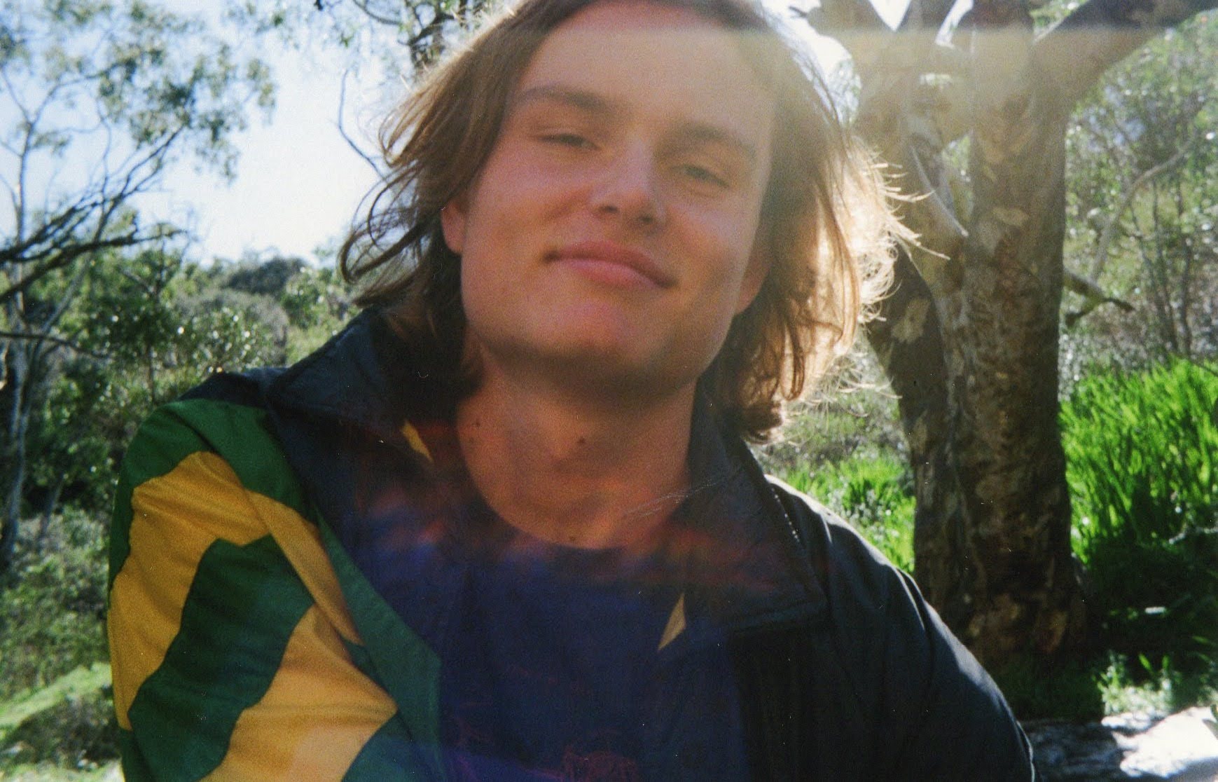 Leif smiling in the sun, surrounded by bushland